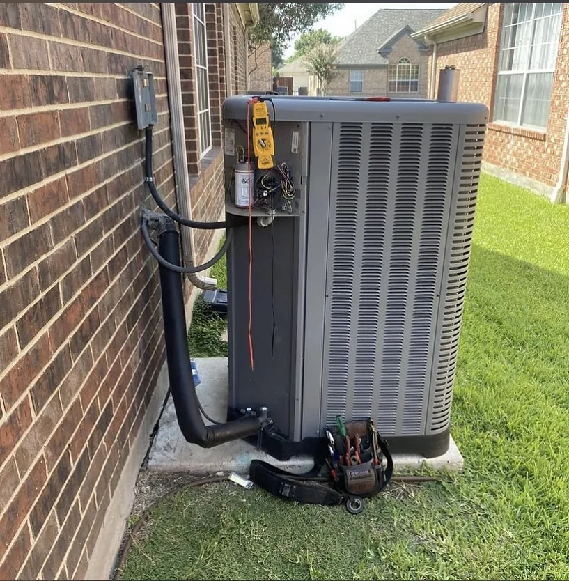 New outdoor HVAC condenser being tested after installation.
