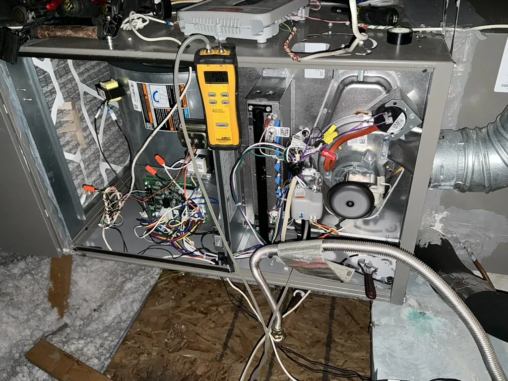 Open HVAC system undergoing electrical and operational diagnostic testing.